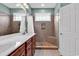 Bathroom featuring double sinks, wood cabinetry, and a walk-in shower with tiled walls at 1018 Red Sky Ln. # 101, Murrells Inlet, SC 29576