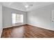 A bright bedroom with a tray ceiling and a ceiling fan over hardwood floors at 1018 Red Sky Ln. # 101, Murrells Inlet, SC 29576