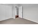 This bedroom features neutral carpeting and paint, a closet with double doors, and is adjacent to another room at 1018 Red Sky Ln. # 101, Murrells Inlet, SC 29576