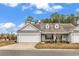 Charming single-story home with a well-maintained front yard and attached garage at 1018 Red Sky Ln. # 101, Murrells Inlet, SC 29576