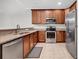 Stylish kitchen featuring stainless steel appliances, granite countertops, and warm wood cabinets at 1018 Red Sky Ln. # 101, Murrells Inlet, SC 29576