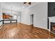 Open living room showcasing wood floors, a fireplace, and access to the kitchen area at 1018 Red Sky Ln. # 101, Murrells Inlet, SC 29576