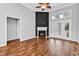 Bright living room showcasing hardwood floors, a fireplace, and access to outdoor space at 1018 Red Sky Ln. # 101, Murrells Inlet, SC 29576