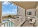 Relaxing balcony featuring ocean views, community pool, and comfortable seating at 1113 N Ocean Blvd. # 101, Surfside Beach, SC 29575