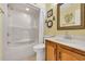 Bathroom featuring a shower-tub combination, a sink with wood cabinetry, and decorative accents at 1113 N Ocean Blvd. # 101, Surfside Beach, SC 29575