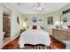 Comfortable bedroom with hardwood floors, a white quilt, a colorful rug, and bright decor at 1113 N Ocean Blvd. # 101, Surfside Beach, SC 29575