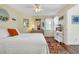 Bedroom with bed, dresser, TV, and bright, colorful accents and decor at 1113 N Ocean Blvd. # 101, Surfside Beach, SC 29575