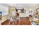 Bright dining area with glass table, wicker chairs, and views into the kitchen at 1113 N Ocean Blvd. # 101, Surfside Beach, SC 29575