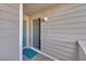 View of the condo's exterior entrance door with adjacent door and muted green, neutral, and gray color scheme at 1113 N Ocean Blvd. # 101, Surfside Beach, SC 29575