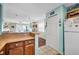 Open kitchen area with wood cabinetry offering views into the living area at 1113 N Ocean Blvd. # 101, Surfside Beach, SC 29575