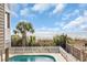 Beautiful ocean view from a private pool with mature palm trees and white picket fence at 1113 N Ocean Blvd. # 101, Surfside Beach, SC 29575