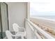 A serene balcony view shows a sandy beach with ocean in the background at 1205 S Ocean Blvd. # 20409, Myrtle Beach, SC 29577