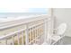 A charming balcony view showcases a sandy beach with gentle waves at 1205 S Ocean Blvd. # 20409, Myrtle Beach, SC 29577
