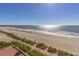 Expansive beach view, with umbrellas and sunlight reflecting on gentle waves at 1205 S Ocean Blvd. # 20409, Myrtle Beach, SC 29577