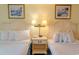 Relaxing bedroom featuring two beds and a convenient bedside table at 1205 S Ocean Blvd. # 20409, Myrtle Beach, SC 29577