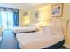 Bright bedroom featuring two beds and a balcony with scenic ocean views at 1205 S Ocean Blvd. # 20409, Myrtle Beach, SC 29577