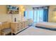 Cozy bedroom featuring two beds, a dresser, and a balcony with ocean views at 1205 S Ocean Blvd. # 20409, Myrtle Beach, SC 29577