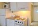 Efficient kitchenette featuring a stove, sink, microwave, and refrigerator at 1205 S Ocean Blvd. # 20409, Myrtle Beach, SC 29577