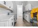 Well-organized laundry room features white cabinets, a countertop, modern appliances and lots of storage at 1256 Fiddlehead Way, Myrtle Beach, SC 29579