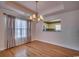 Elegant dining room featuring hardwood floors, tray ceiling, and view into the modern kitchen at 1525 Sunmeadow Dr., Conway, SC 29526