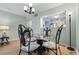 Dining room area featuring a glass table, decorated chairs and a view into the kitchen at 180 Rothbury Circle # 302, Myrtle Beach, SC 29572
