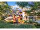 Exterior view of building, highlighting Unit #302 balcony and surrounded by lush greenery and mature trees at 180 Rothbury Circle # 302, Myrtle Beach, SC 29572