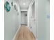 Hallway with light wood floors and coastal-themed decor at 180 Rothbury Circle # 302, Myrtle Beach, SC 29572