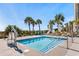 Relaxing hot tub with easy access via a lift chair, surrounded by palm trees and lounge chairs for a tranquil experience at 180 Rothbury Circle # 302, Myrtle Beach, SC 29572