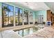 Indoor hot tub with large windows and tiled surround, providing natural light and exterior views at 180 Rothbury Circle # 302, Myrtle Beach, SC 29572
