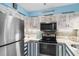Cozy kitchen featuring stainless steel appliances, cabinets with unique fronts and countertops at 180 Rothbury Circle # 302, Myrtle Beach, SC 29572