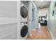 Convenient laundry area featuring stacked washer and dryer units with hallway access to the rest of the condo at 180 Rothbury Circle # 302, Myrtle Beach, SC 29572
