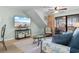 Bright living room showcases a flatscreen TV, comfortable seating, and access to a balcony with scenic views at 180 Rothbury Circle # 302, Myrtle Beach, SC 29572