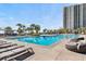 Enjoy a large swimming pool surrounded by lush palm trees and comfortable lounge chairs, perfect for sunny days at 180 Rothbury Circle # 302, Myrtle Beach, SC 29572