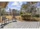 Comfortable outdoor seating on a covered back porch with serene views of the surrounding landscape at 1820 Spinnaker Dr., North Myrtle Beach, SC 29582