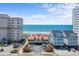 Beach view featuring colorful buildings, sandy shores, and ocean at 1820 Spinnaker Dr., North Myrtle Beach, SC 29582
