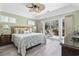 Relaxing bedroom with a ceiling fan, light green walls, and sliding doors at 1820 Spinnaker Dr., North Myrtle Beach, SC 29582