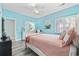 A calming bedroom with light blue walls, white trim, and shuttered windows at 1820 Spinnaker Dr., North Myrtle Beach, SC 29582