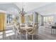 Dining room with a chandelier, large arched window, and a view to the living room at 1820 Spinnaker Dr., North Myrtle Beach, SC 29582