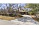 Charming single-story home with mature trees, lush landscaping, and a circular driveway at 1820 Spinnaker Dr., North Myrtle Beach, SC 29582