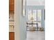 Hallway with a sidelight to a bedroom and a partial view of the kitchen at 1820 Spinnaker Dr., North Myrtle Beach, SC 29582