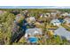 An aerial view of multiple homes with a community pool, waterfront access and lush greenery at 186 Cayman Loop, Pawleys Island, SC 29585