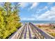 Beach access walkway with greenery to the side leading to ocean views, sunny skies, and sandy beaches at 186 Cayman Loop, Pawleys Island, SC 29585