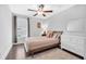 Bedroom featuring hardwood floors, neutral paint, a decorative ceiling fan, an area rug, dresser and queen bed at 186 Cayman Loop, Pawleys Island, SC 29585