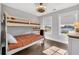 Bright bedroom with a bunk bed, neutral paint, decorative ceiling fan, and hardwood floors at 186 Cayman Loop, Pawleys Island, SC 29585