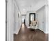 Hallway featuring hardwood floors, neutral paint, an area rug and a decorative chair at 186 Cayman Loop, Pawleys Island, SC 29585