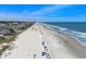 Beautiful aerial view of the beach showcasing the shoreline, ocean, and nearby houses at 2000 N Waccamaw Dr., Garden City Beach, SC 29576