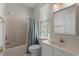 Cozy bathroom with tub-shower combo, vanity, and a well-lit mirror at 2000 N Waccamaw Dr., Garden City Beach, SC 29576