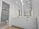 Bathroom with a double vanity, modern fixtures, recessed lighting, and a step-in shower at 2000 N Waccamaw Dr., Garden City Beach, SC 29576