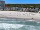 Stunning beach view shows houses along the sandy shore, inviting beachgoers for relaxation and recreation at 2000 N Waccamaw Dr., Garden City Beach, SC 29576