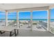 Relaxing covered deck features rocking chairs, lounge seating, and a picnic table with stunning beach views at 2000 N Waccamaw Dr., Garden City Beach, SC 29576